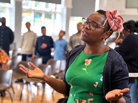 Pastor Funke worshipping with her hands open